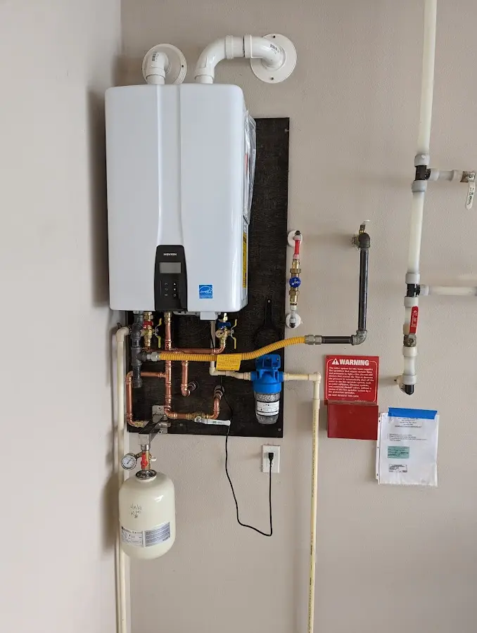 Professional plumber installing copper piping in a Glen Allen home